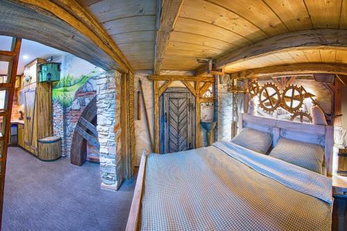 a bedroom with a bed in a room with a mural at Hotel Kocourkov in Hlinsko