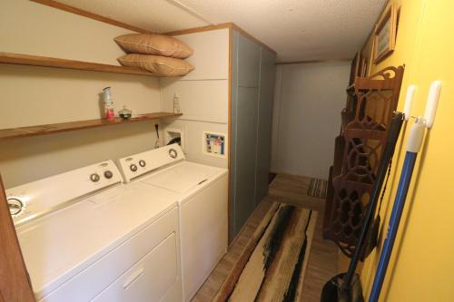 a kitchen with a washer and dryer in a room at Cozy Tennessee Plateau home with furnished outdoor living and 1G Wi-Fi in Crossville