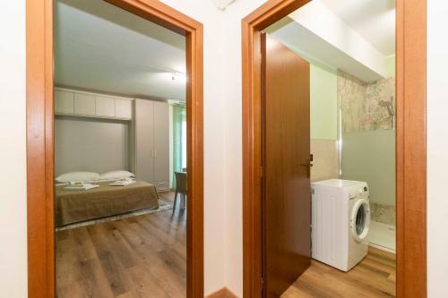 a door leading to a room with a washing machine at Torino Comfy Apt in Turin