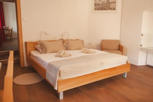 a bed with two towels on it in a room at Rooms & Apartments Podsreda Castle in Podsreda