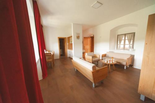 a living room with a couch and a table at Rooms & Apartments Podsreda Castle in Podsreda