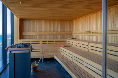 a sauna with wooden benches in a building at Petram Resort & Residences in Savudrija