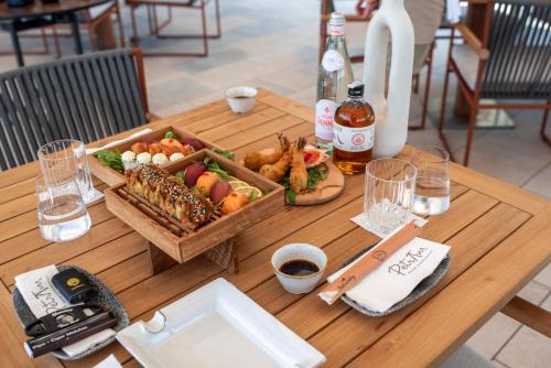 a wooden table with a tray of food on it at Petram Resort & Residences in Savudrija