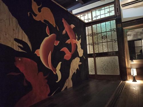 a room with a painting on the wall at まろや四季 in Ōzu