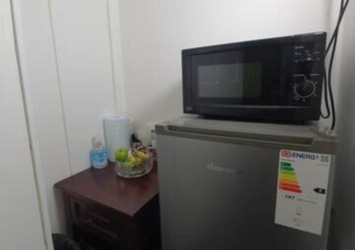 a microwave sitting on top of a refrigerator at Modern En-suite Doubles in Boston Town Spacious & Contemporary Rooms in Boston
