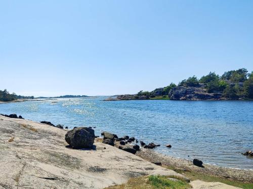 a body of water with rocks on the shore at 7 person holiday home in STRöMSTAD-By Traum in Strömstad