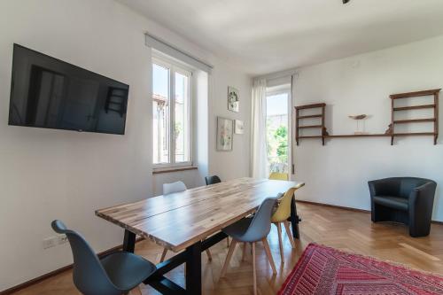 a dining room with a wooden table and chairs at Giuka Apartment by Quokka 360 - close to the station in Massagno