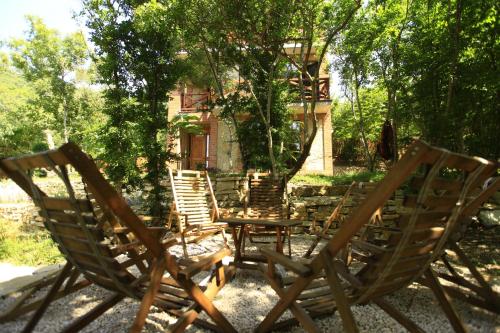 a group of chairs sitting in front of a house at Villa Vejini in Mamkoda