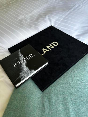 a book sitting on top of a bed at Studio 104- Free PARKING onsite -Private entrance in Reykjavík
