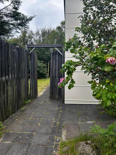a door leading into a garden with a fence at Studio 104- Free PARKING onsite -Private entrance in Reykjavík