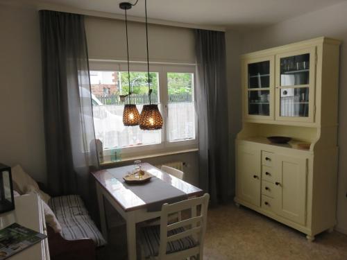 a kitchen with a table and a window at Ferienwohnung Auszeit in Bad König