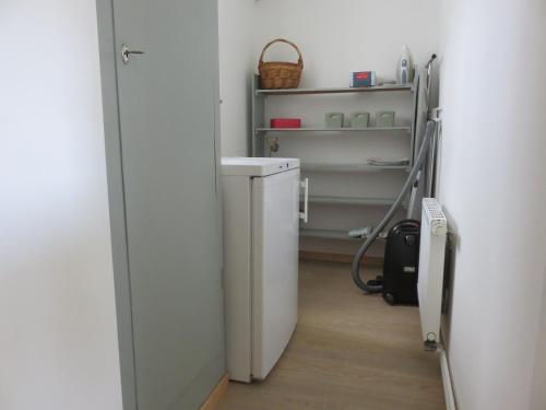 a hallway with a white refrigerator in a room at Ferienwohnung Auszeit in Bad König