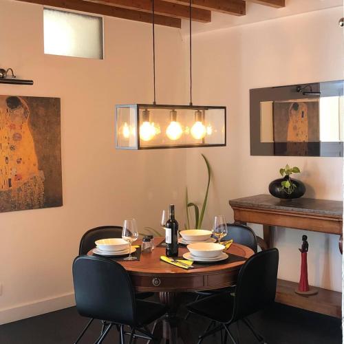 a dining room with a table with chairs and a chandelier at Penthouse 120 m2 vue imprenable Lattes in Lattes