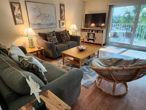 a living room with a couch and a table at Holiday Villas II ON THE BEACH w/Intercoastal View in Clearwater Beach