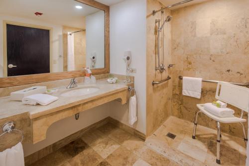 a bathroom with a sink and a mirror at Holiday Inn Monterrey Valle by IHG in Monterrey