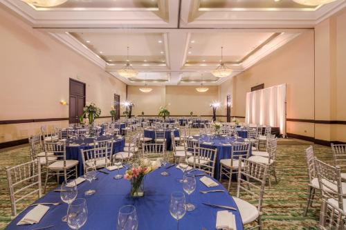 a banquet hall with blue tables and chairs at Holiday Inn Monterrey Valle by IHG in Monterrey