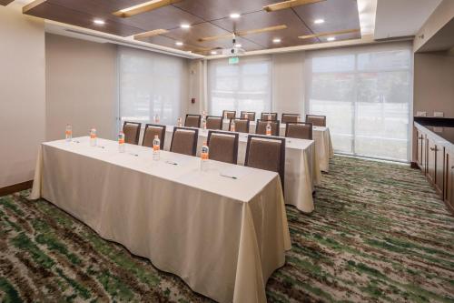 a conference room with rows of tables and chairs at Holiday Inn Monterrey Valle by IHG in Monterrey