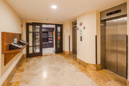 a hallway with elevators in a building at Holiday Inn Monterrey Valle by IHG in Monterrey