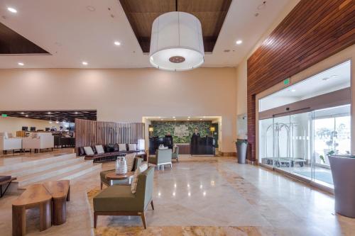 a lobby of a hotel with chairs and tables at Holiday Inn Monterrey Valle by IHG in Monterrey