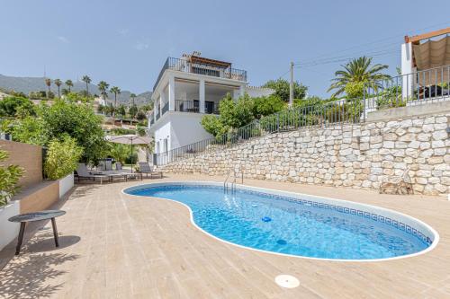 a swimming pool in front of a building at Luxury Villa Alhambra close to Sea and Centre in Benalmádena