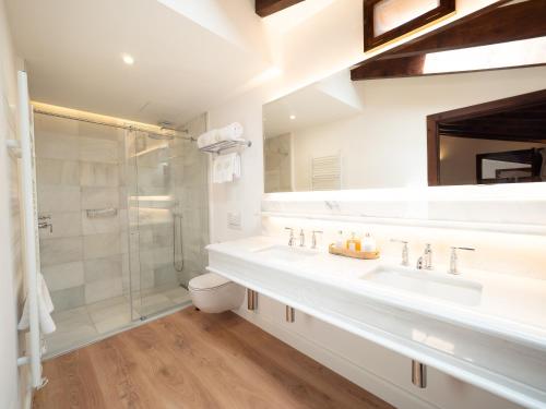 a white bathroom with a sink and a shower at Ca'n Puig de Sòller in Sóller