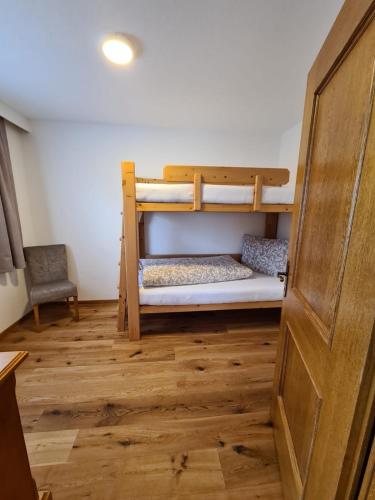 a room with two bunk beds and a door at Apartment Huter in Jerzens
