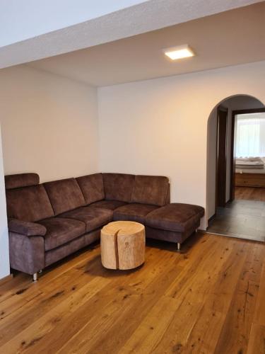 a living room with a brown couch and a table at Apartment Huter in Jerzens
