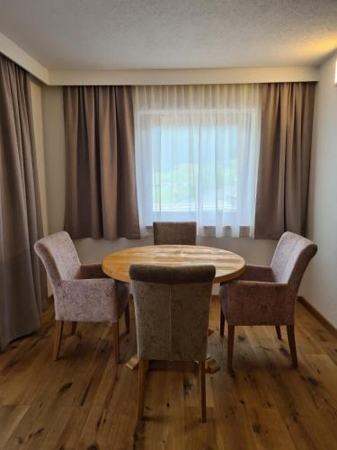 a dining room with a table and chairs and a window at Apartment Huter in Jerzens