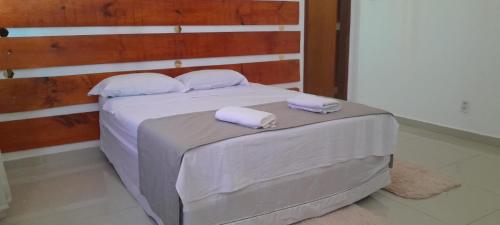 a bedroom with a bed with two towels on it at Central Palace Hotel in Fortaleza