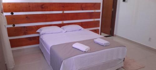 a bedroom with a bed with two white towels on it at Central Palace Hotel in Fortaleza