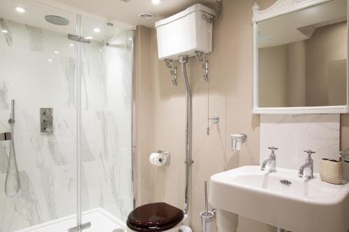 a bathroom with a shower and a sink and a toilet at The Bakery in Arundel