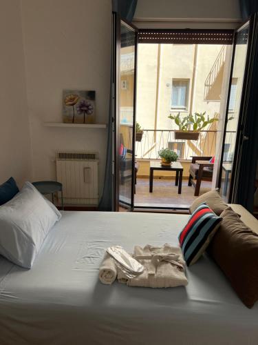 a bedroom with a bed with a towel on it at Golden House - Trilocale nel Cuore di Agrigento in Agrigento