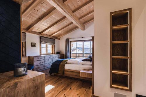 a bedroom with a bed and a large window at Chalet am Wetterkreuz in Reit im Winkl