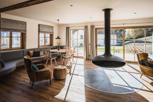 a living room with a fireplace and a dining room at Chalet am Wetterkreuz in Reit im Winkl