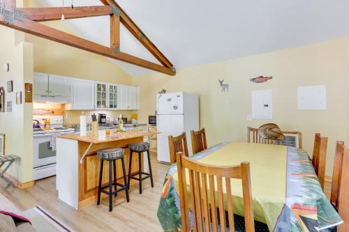 a kitchen and dining room with a table and chairs at Pools and Ski Access Lackawaxen Cottage with Deck! in Lackawaxen