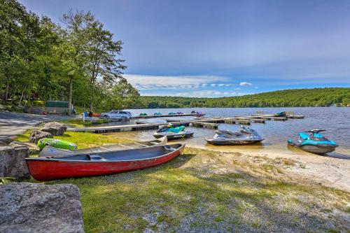 a group of boats sitting on the shore of a lake at Pools and Ski Access Lackawaxen Cottage with Deck! in Lackawaxen