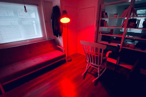 a red room with a bench and a window at City Loft - O2 & Excel Center in London