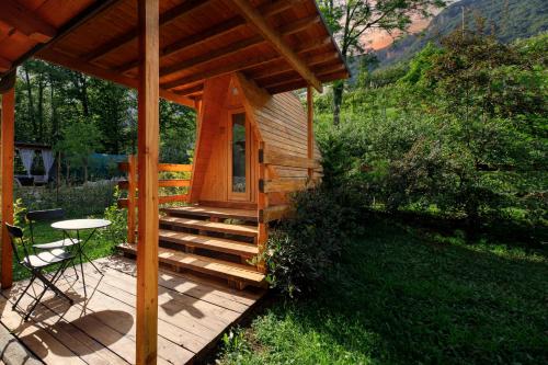 a small wooden cabin with a table on a deck at Agriturismo Scuderia della Valle in Valsecca