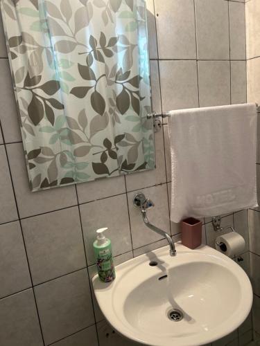 a bathroom with a sink and a shower curtain at The heart of Sarajevo in Sarajevo