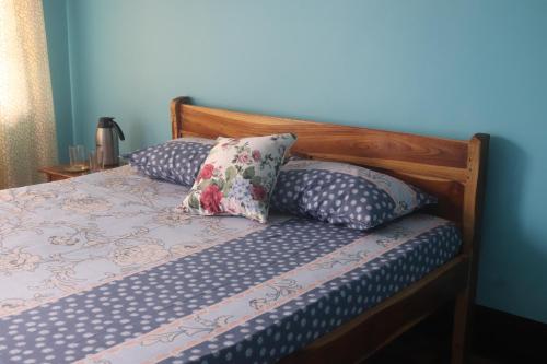 a bed with two pillows on top of it at Sparrow Nest Homestay in Darjeeling