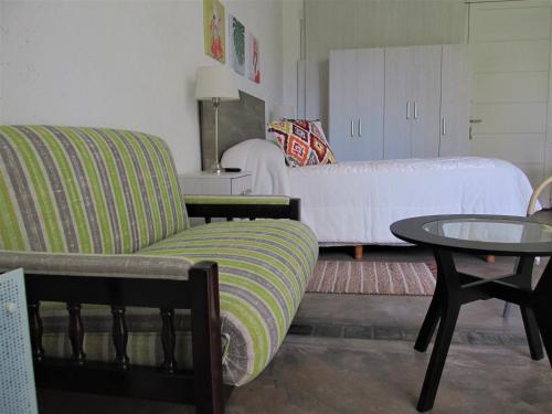 a living room with a couch and a table at Habitación doble, baño privado. in Maipú