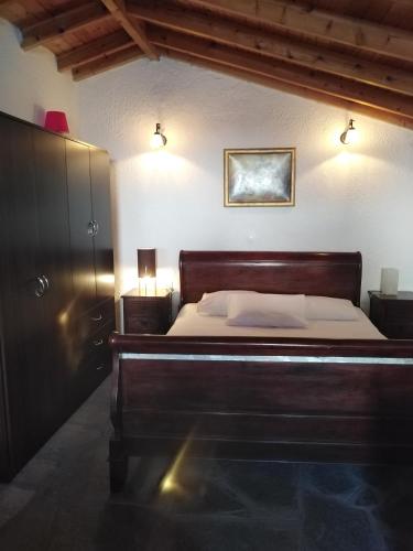 a bedroom with a bed and two lights on the wall at Rebekka's Guest House Elani in Siviri