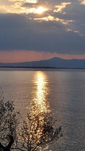 a sunset over a large body of water at 貸別荘せせらぎ in Taga