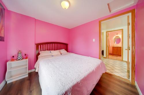 een roze slaapkamer met een bed in een kamer bij Flamingo Geneva Getaway Steps to Lake Erie! in Geneva