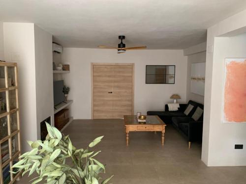 uma sala de estar com um sofá e uma mesa em Villa AURA 500 metros de la playa em Torre de Benagalbón