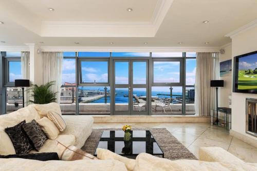 a living room with a couch and a large window at Luxury City Center Penthouse - Best Location in Galway