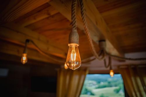 a group of lights hanging from a ceiling at Beskidzka Oaza in Istebna