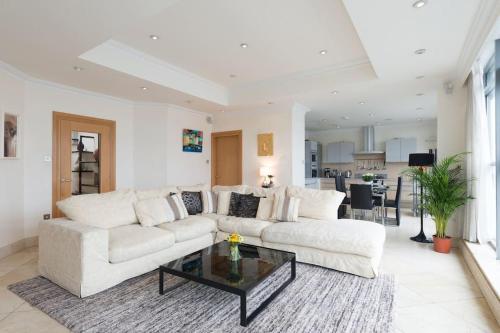 a living room with a white couch and a coffee table at Luxury City Center Penthouse - Best Location in Galway