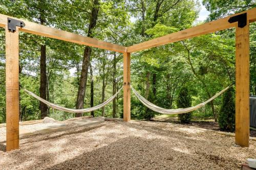 a wooden pergola with a hammock at Spacious Home on Beaver Lake with Deck and Fire Pit! in Rogers