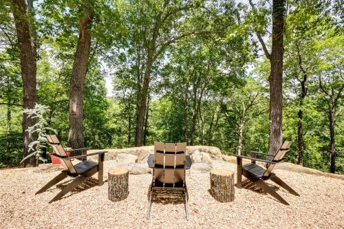 two chairs and a table in the woods at Spacious Home on Beaver Lake with Deck and Fire Pit! in Rogers